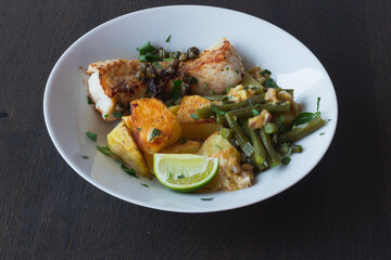 Baked white cod fish, bacalhau, with roasted potatoes and simple skillet green beans