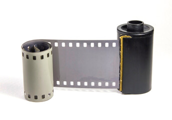 Roll of undeveloped 35 mm, black and white negative photographic film on a white background 