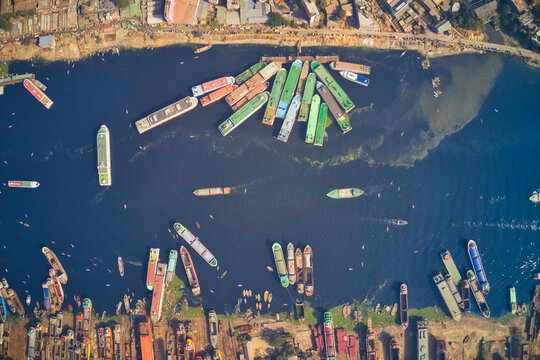 Aerial view of colourful ferry boat docket at small wharf along Buriganga river in Keraniganj, Dhaka, Bangladesh.
