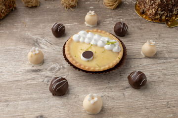 lemon dessert with chocolate balls around, detail of pastry in studio