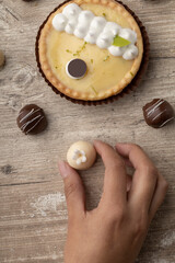 a person decorating a lemon cake and some chocolate balls, elegant design in studio