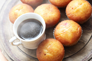 Delicious fresh muffins with berry filling and a cup of coffee