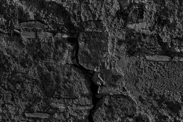 Texture of medieval crumbling stone basement wall. Large hard cobblestones of natural rocky block cement structure. Dirty broken bumpy shabby daub. Retro aged vintage messy masonry for design material
