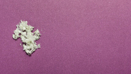 Hazardous mineral asbestos close-up on a fiolet background. Copy space