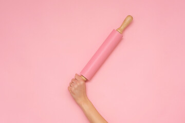Kitchen roller on a pink background.