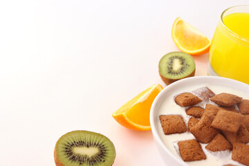 Healthy lifestyle. Healthy breakfast with a glass of juice and fruit. Fruit and sweet pads for breakfast. Orange and kiwi. Healthy breakfast on a white background.