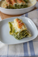 Cannelloni with ricotta and wild garlic spinach. Italian cuisine