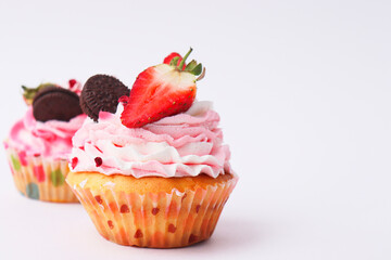 cupcake with pink frosting and sprinkles