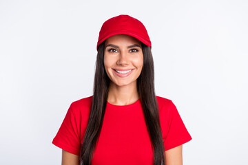 Photo of young happy cheerful smiling service worker delivery girl wear red t-shirt and cap isolated on grey color background