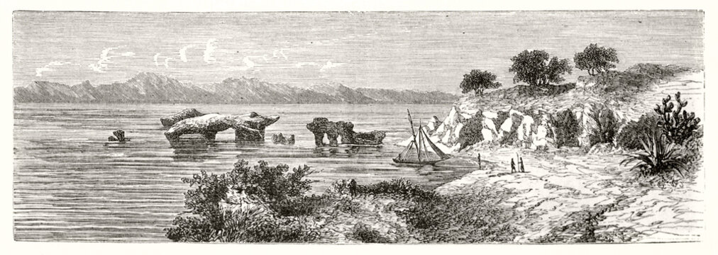 Horizontal sea scape with shore, sea, rocks rising from water and mountains far in the distance at Bay of Anfile, Eritrea. Ancient grey tone etching style art by De Bar, Magasin Pittoresque, 1838