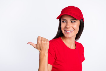 Photo of young happy cheerful lovely charming service girl point finger copyspace promo isolated on grey color background