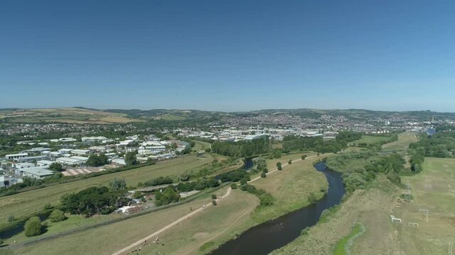 Marsh barton industrial estate in Exeter. In the foreground in the river exe surrounded by pasture and nature reserve land