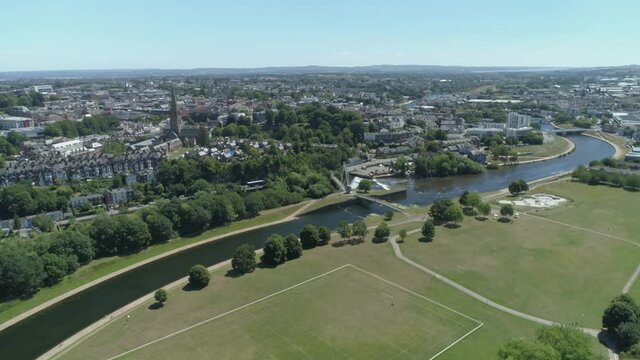 Exeter skyline aerial encapsulating playing fields, parks, the river exe, residential and commercial estates and city centre.