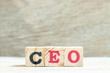 Alphabet letter block in word CEO (Abbreviation of Chief Executive Officer) on wood background