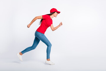 Full size profile side photo of young happy cheerful excited delivery girl run fast in air isolated on grey color background