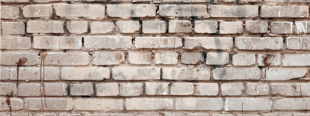 Urban background, empty grunge industrial street with brick wall half white and orange brown, covered with plaster paint graffiti, city street backdrop