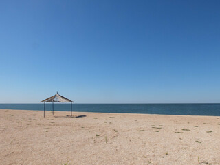 Gazebo at sandy beach of sea