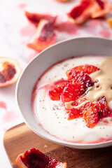 Fresh healthy breakfast greek yogurt with blood oranges, cashew butter and chia seeds