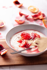 Fresh healthy breakfast greek yogurt with blood oranges, cashew butter and chia seeds