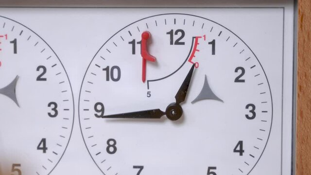Second clock pointer moves measuring player move period on white face of vintage chess timer on table extreme close view