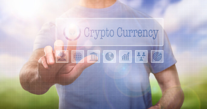A man in a t-shirt outside selecting a Crypto Currency word concept on a computerised display