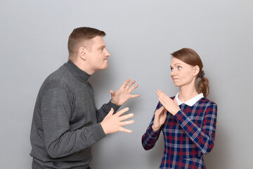 Portrait of couple talking, quarrelling and actively gesturing