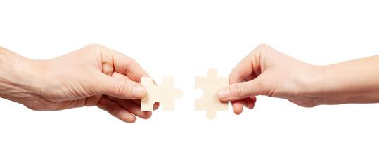 Business cooperation. Two hands connect a puzzle on a white background. Joint problem solving, mutual assistance. - obrazy, fototapety, plakaty