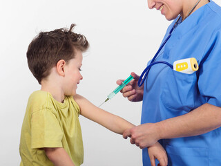 unrecognizable nurse smiles while vaccinating elementary child - obrazy, fototapety, plakaty