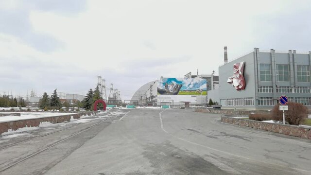 At the Chernobyl Nuclear Power Plant or ChNPP. New Safe Confinement on a background.