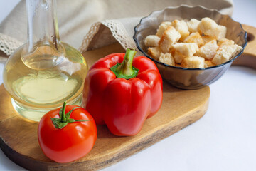 Healthy snack, vegetables, olive oil and crackers on a wooden board