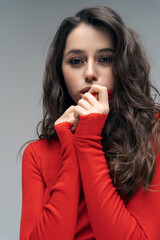 Pretty brunette woman in red looking at camera