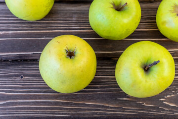 Green apples on wooden background
