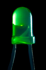 Glowing green LED with a diameter of 3 mm on a black background