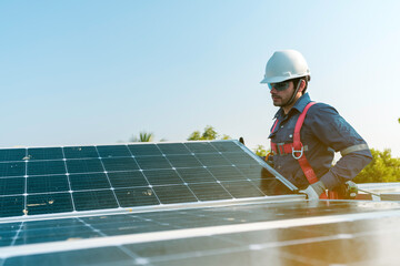 A technician installing the solar panels at roof top of home and home office ,concept of economic energy and cost saving ,own small business