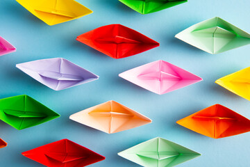 Paper boats of multi-colour. Concept for leadership and teamwork