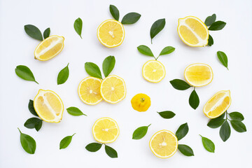 Fresh lemon with green leaves on white.