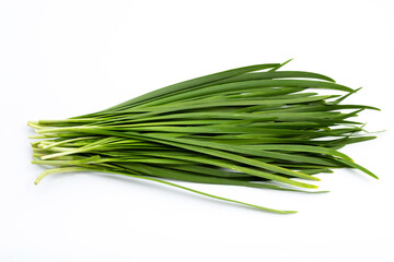 Fresh Chinese Chive leaves on white.