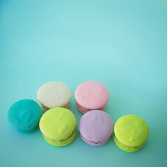 colorful macaroons on a blue square textural background
