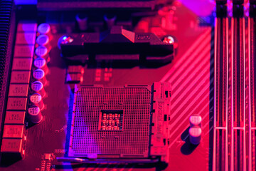 Blurred background. Socket am4. Close up of the AM4 socket for the motherboard with neon blue and red lights. Technological background