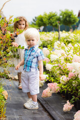 Cute blonde boy outdoor at botanical garden