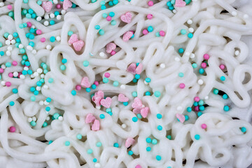 The texture of icing on a cake with pastry sprinkles, macro photography