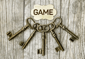 Escape room game concept, old vintage keys on old wooden background 