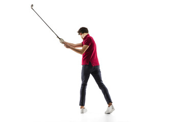 Golf player in a red shirt taking a swing isolated on white studio background with copyspace. Professional player practicing confident, emotions and facial expression. Sport, motion, action concept.