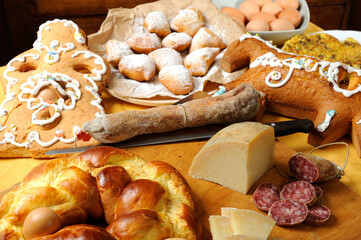 Easter breakfast typical of the Abruzzo region in Italy with Easter pizza eggs salami sweet cheese called pupa and bocconotti typical Abruzzo dessert