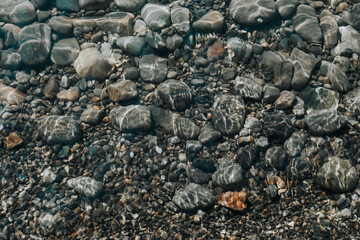 Pure sea water of the Black Sea. Pebble sea shore background.
