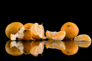 tangerines on a black background, crushed ice, ice cubes