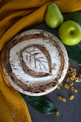 Crusty bread on a yellow kitchen towel. Top view photo of fresh baked sourdough bread.  Still life food.