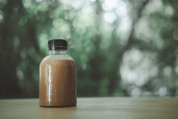Cocoa in mini plastic bottle  on wood table