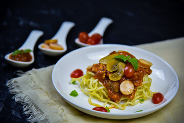 Delicious classic Italian spaghetti with tomato sauce, Parmesan cheese and mint leaves on a plate. There is a writing area.