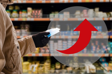 Man in grocery store prefer paying for purchases by credit card, not cash. the arrow shows the rise...
